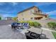 Landscaped backyard showcasing a patio with an outdoor seating area and artificial grass at 9990 Perth Ct, Las Vegas, NV 89141
