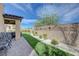 Beautiful backyard with artificial turf, brick border, and patio area, perfect for outdoor entertaining at 9990 Perth Ct, Las Vegas, NV 89141