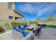 Spacious backyard featuring outdoor seating and artificial turf, perfect for relaxation and entertainment at 9990 Perth Ct, Las Vegas, NV 89141