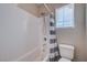 Clean bathroom showcasing a white subway tile shower with a gray striped curtain and modern fixtures at 9990 Perth Ct, Las Vegas, NV 89141