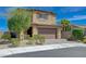 Charming two-story home featuring a well-manicured front yard and inviting curb appeal at 9990 Perth Ct, Las Vegas, NV 89141