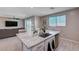 Kitchen island with stainless steel sink and faucet, and dishwasher at 9990 Perth Ct, Las Vegas, NV 89141