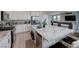 Open kitchen boasts a large granite island, stainless appliances, and seamless flow to the living area at 9990 Perth Ct, Las Vegas, NV 89141