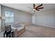 Spacious living room with neutral carpet, ceiling fan, and comfortable seating, creating a serene and inviting atmosphere at 9990 Perth Ct, Las Vegas, NV 89141