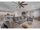 Open-concept living room featuring a large sectional and view to a kitchen at 9990 Perth Ct, Las Vegas, NV 89141