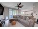 Open-concept living room featuring a large sectional and view to a kitchen at 9990 Perth Ct, Las Vegas, NV 89141