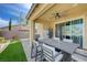 Relaxing covered patio area with an outdoor dining set, ideal for enjoying al fresco meals at 9990 Perth Ct, Las Vegas, NV 89141