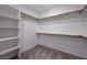 Walk-in closet featuring ample shelving and rod space, offering abundant storage and organization at 9990 Perth Ct, Las Vegas, NV 89141