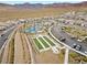 Aerial view of tennis courts and bocce ball court with desert landscape at 12476 Heritage Bend Dr, Las Vegas, NV 89138