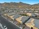 An aerial view shows a residential neighborhood and mountain views at 12476 Heritage Bend Dr, Las Vegas, NV 89138