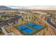 Aerial view of tennis courts and bocce ball court with mountain view at 12476 Heritage Bend Dr, Las Vegas, NV 89138