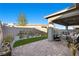 Charming backyard featuring a cozy outdoor seating area, artificial turf, and a brick privacy wall at 12476 Heritage Bend Dr, Las Vegas, NV 89138