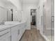 Bright bathroom featuring double vanity, glass shower, and modern fixtures at 12476 Heritage Bend Dr, Las Vegas, NV 89138