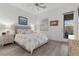 Well-lit bedroom features neutral decor, pendant lighting, and a private patio at 12476 Heritage Bend Dr, Las Vegas, NV 89138