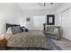 Bright bedroom with a plush patterned chair, complementing pillows, and a stylish rug at 12476 Heritage Bend Dr, Las Vegas, NV 89138