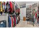 Spacious walk-in closet with custom shelving, hanging rods and a chair for convenience at 12476 Heritage Bend Dr, Las Vegas, NV 89138