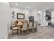 Bright dining room features a wooden table, neutral chairs and modern lighting at 12476 Heritage Bend Dr, Las Vegas, NV 89138