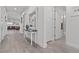 Bright entryway with wood floors, decorative mirror, and view into open living spaces at 12476 Heritage Bend Dr, Las Vegas, NV 89138