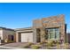 Charming one-story home featuring a two-car garage, stone accents, and well-maintained landscaping at 12476 Heritage Bend Dr, Las Vegas, NV 89138