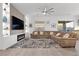 Spacious living room features a modern fireplace, built-in shelving and large sectional sofa at 12476 Heritage Bend Dr, Las Vegas, NV 89138