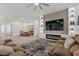 Open living room with a modern fireplace, built-in shelving, and access to dining room at 12476 Heritage Bend Dr, Las Vegas, NV 89138