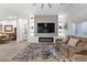 Bright living room featuring a fireplace, built-in shelving, and comfortable seating at 12476 Heritage Bend Dr, Las Vegas, NV 89138