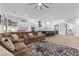 Spacious living room with view of the open kitchen and dining area and modern design elements at 12476 Heritage Bend Dr, Las Vegas, NV 89138