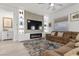 Cozy living room showcases a modern fireplace, built-in shelving and an inviting sectional sofa at 12476 Heritage Bend Dr, Las Vegas, NV 89138