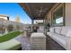 A beautiful outdoor patio features brick pavers, modern furniture, and a ceiling fan for comfortable outdoor living at 12476 Heritage Bend Dr, Las Vegas, NV 89138