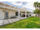 Well-maintained backyard with a covered patio, lush lawn, and privacy fencing, perfect for outdoor activities at 2212 Marble Gorge Dr, Las Vegas, NV 89117