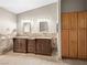 Bathroom features a double vanity with granite countertops and beautiful accent wall at 2212 Marble Gorge Dr, Las Vegas, NV 89117