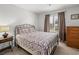 Bedroom featuring a bed, nightstand and large window with natural light at 2212 Marble Gorge Dr, Las Vegas, NV 89117