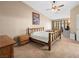 Bright bedroom with high ceilings, large windows, ceiling fan, and wood-framed bed at 2212 Marble Gorge Dr, Las Vegas, NV 89117