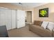 Bedroom with a couch and closet area, featuring neutral walls and great natural light at 2212 Marble Gorge Dr, Las Vegas, NV 89117