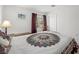 Bedroom featuring a bed, rocking chair and large window with natural light at 2212 Marble Gorge Dr, Las Vegas, NV 89117