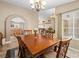 Inviting dining room with decorative floor tiles, wooden table, and an open view to the kitchen and backyard at 2212 Marble Gorge Dr, Las Vegas, NV 89117