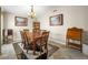 Formal dining room with a wooden table, seating for six, and decorative artwork on the walls at 2212 Marble Gorge Dr, Las Vegas, NV 89117