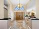 Grand foyer features soaring ceilings, tile floors, large arched window, and decorative, double-door entry at 2212 Marble Gorge Dr, Las Vegas, NV 89117