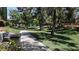 Scenic community pathway with benches and mature trees providing plenty of shade at 2212 Marble Gorge Dr, Las Vegas, NV 89117