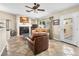 Cozy living room with fireplace, tile flooring, neutral colors, and a sliding glass door to the backyard at 2212 Marble Gorge Dr, Las Vegas, NV 89117