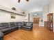 Inviting living room featuring hardwood floors, and a large sectional sofa, with natural light streaming through arched windows at 2212 Marble Gorge Dr, Las Vegas, NV 89117