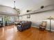 Bright living room featuring hardwood floors, large windows, and a ceiling fan, providing comfortable light at 2212 Marble Gorge Dr, Las Vegas, NV 89117