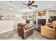 Open living area featuring tile floors, a fireplace, comfortable seating, and a view into the dining room at 2212 Marble Gorge Dr, Las Vegas, NV 89117