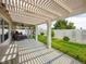 Spacious covered patio with outdoor seating, lush greenery, and ample space for entertaining guests at 2212 Marble Gorge Dr, Las Vegas, NV 89117