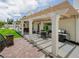Extended covered patio featuring brick flooring, comfortable seating, and a grill for outdoor enjoyment at 2212 Marble Gorge Dr, Las Vegas, NV 89117
