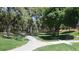 Beautifully landscaped community with a walking path in a tree filled green space at 2212 Marble Gorge Dr, Las Vegas, NV 89117