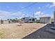 Spacious backyard featuring a utility shed and RV parking area under a bright, partly cloudy sky at 326 W Basic Rd, Henderson, NV 89015