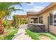 Landscaped backyard featuring artificial turf, a hot tub, and a covered patio at 3528 Tack St, Las Vegas, NV 89122