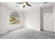 Bright bedroom featuring gray carpet, neutral walls, window and a closet with sliding doors at 3528 Tack St, Las Vegas, NV 89122