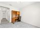 Empty bedroom features gray carpet, desk, and window at 3528 Tack St, Las Vegas, NV 89122